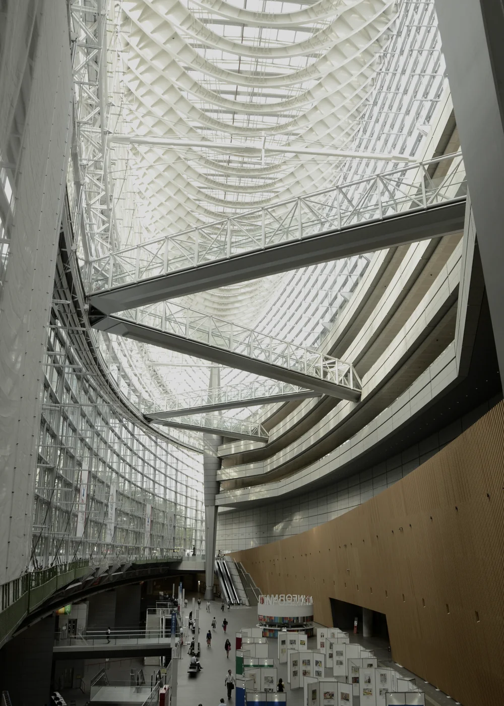 Curving steel trusses and suspended walkways inside the Tokyo International Forum.